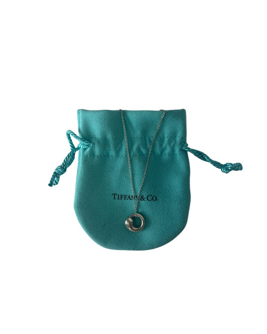 Necklace with blue pouch behind